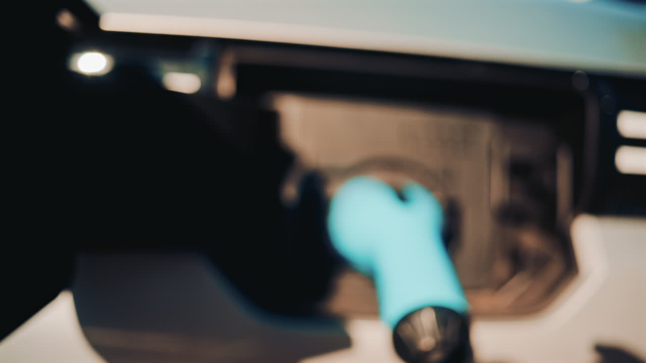 Close up shot of an electric vehicle charging port with cable connected