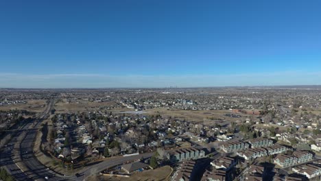 An-afternoon-drone-pan-over-Littleton-Co,-Denver-is-in-the-distance
