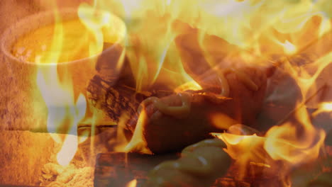 grilling sausage with mustard over open flames, creating smoky atmosphere
