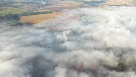 aerial view of clouds and fog at dawn over highway