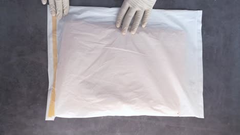 packing an item with protective plastic wrap and tape.