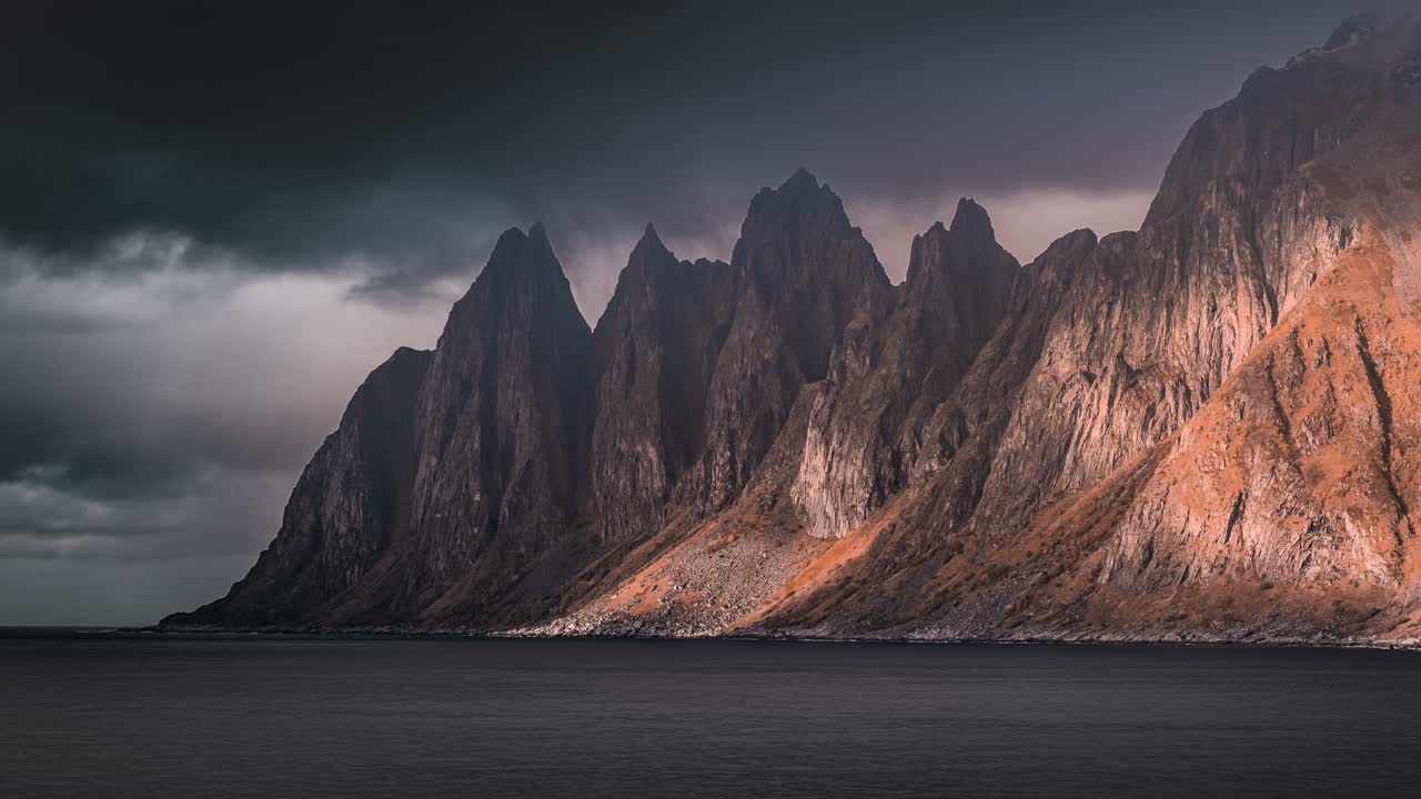 Shadows crawling over the mountain ridge