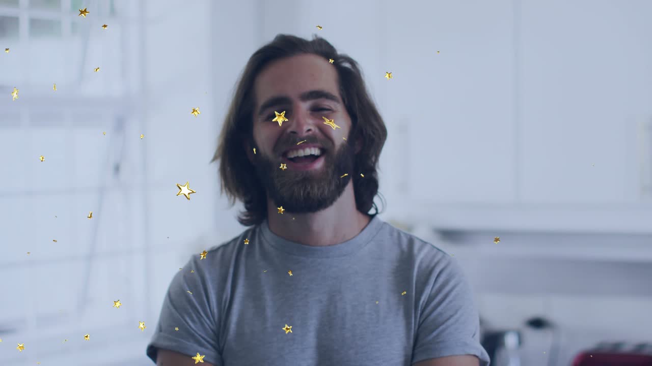 Man reacting to offcam cue in kitchen smile-laugh shifting while gold stars drifting over face ads
