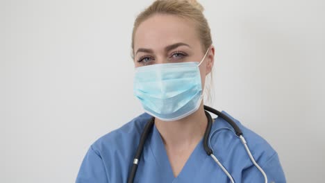 Female-doctor-in-mask-looking-at-camera