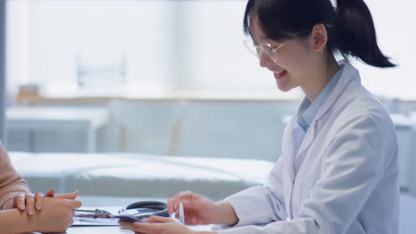 asian tween boy and his mother getting medical consultation