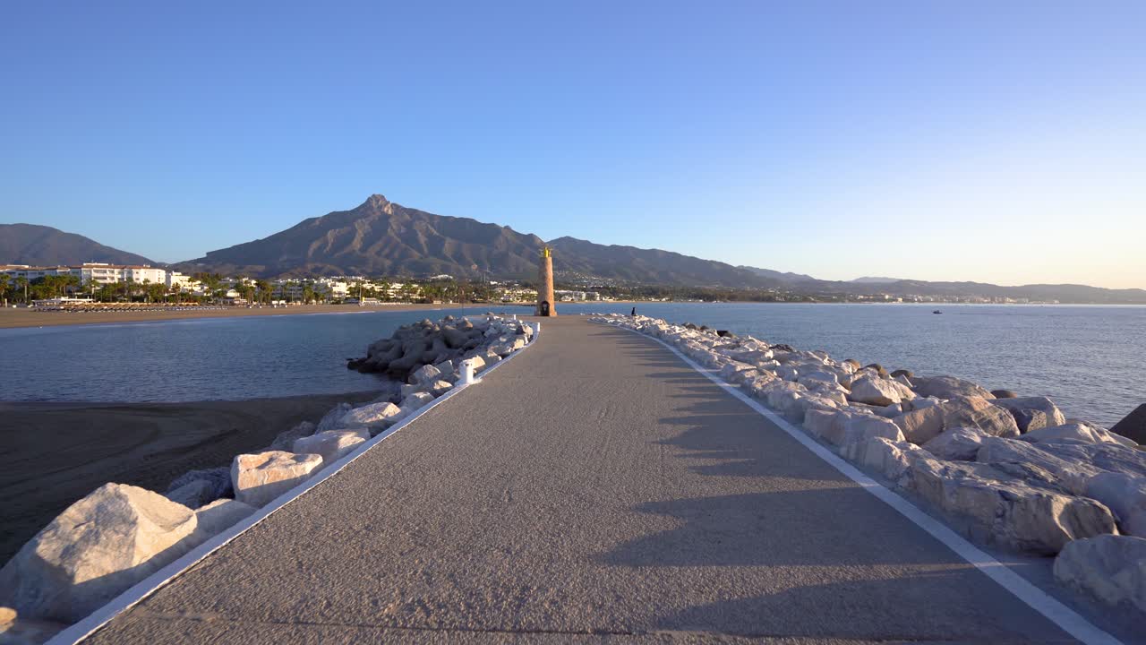 POV walking down Puerto Banus pier on a sunny morning with clear blue sky, shot on gimbal in 4k