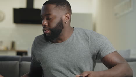 young man playing video game at home. nervous guy holding play station.