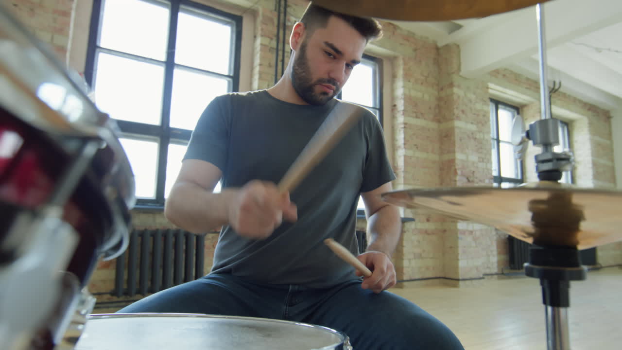 Drum Player Playing Music in Studio