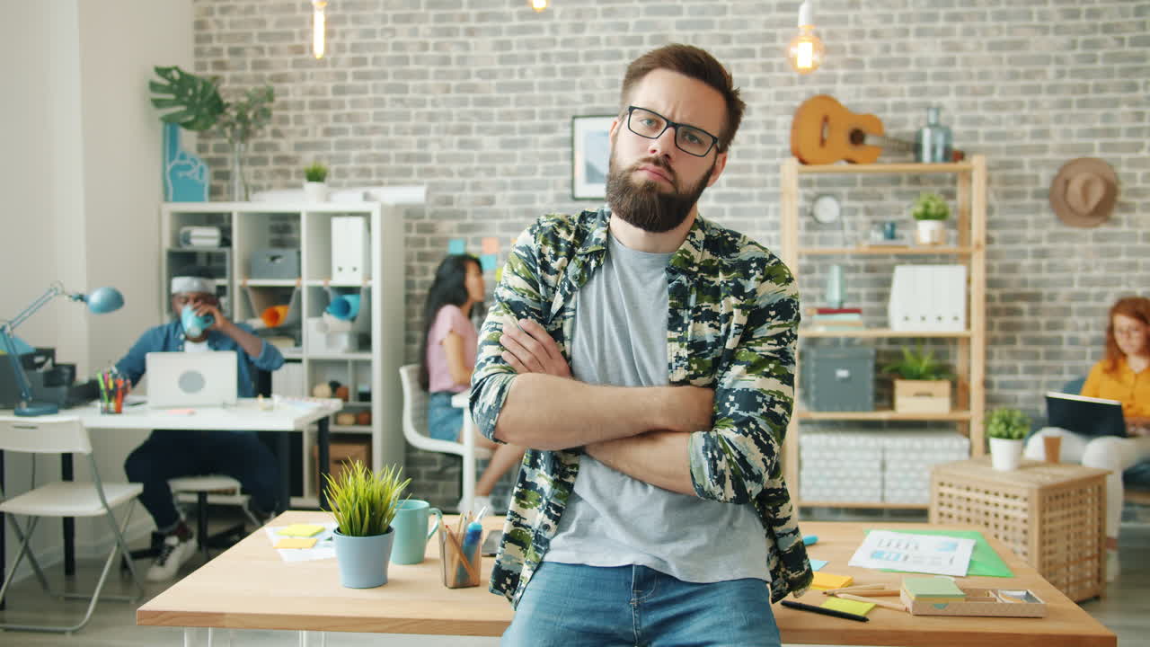 Man with arms crossed in an office setting