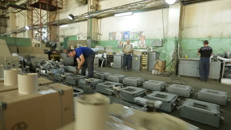 production line inside the factory. bar, ukraine - august 2017: people working in production plant