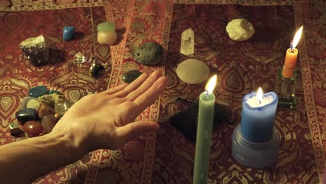 Close-up of a fortune-teller&#039;s pendulum reading the future in one hand