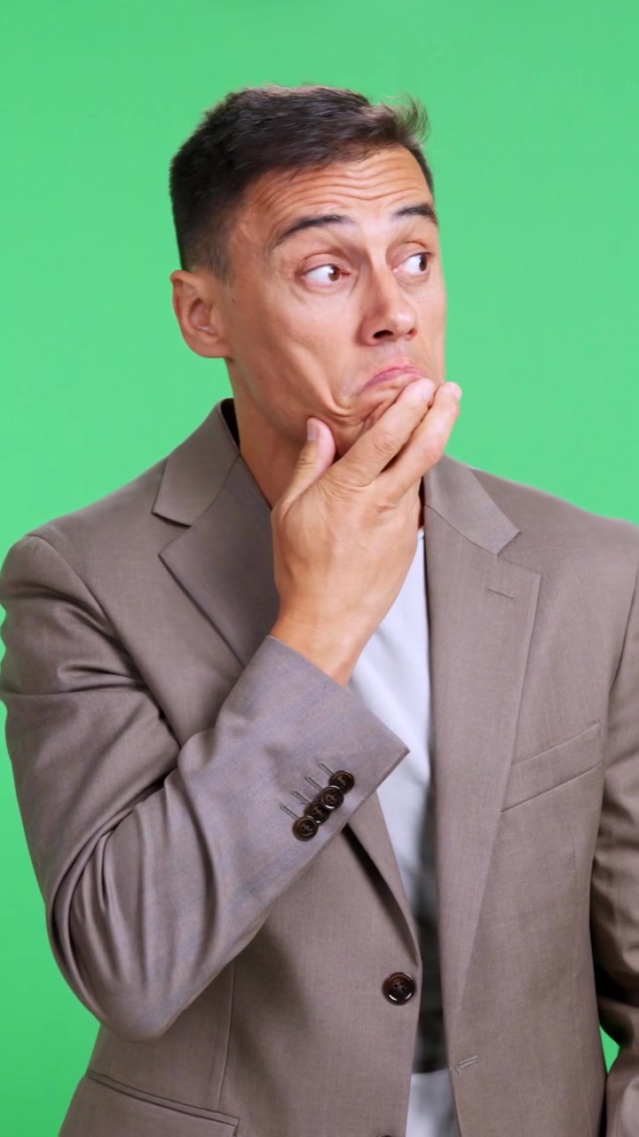 Businessman pretending to whistle nonchalantly on green screen