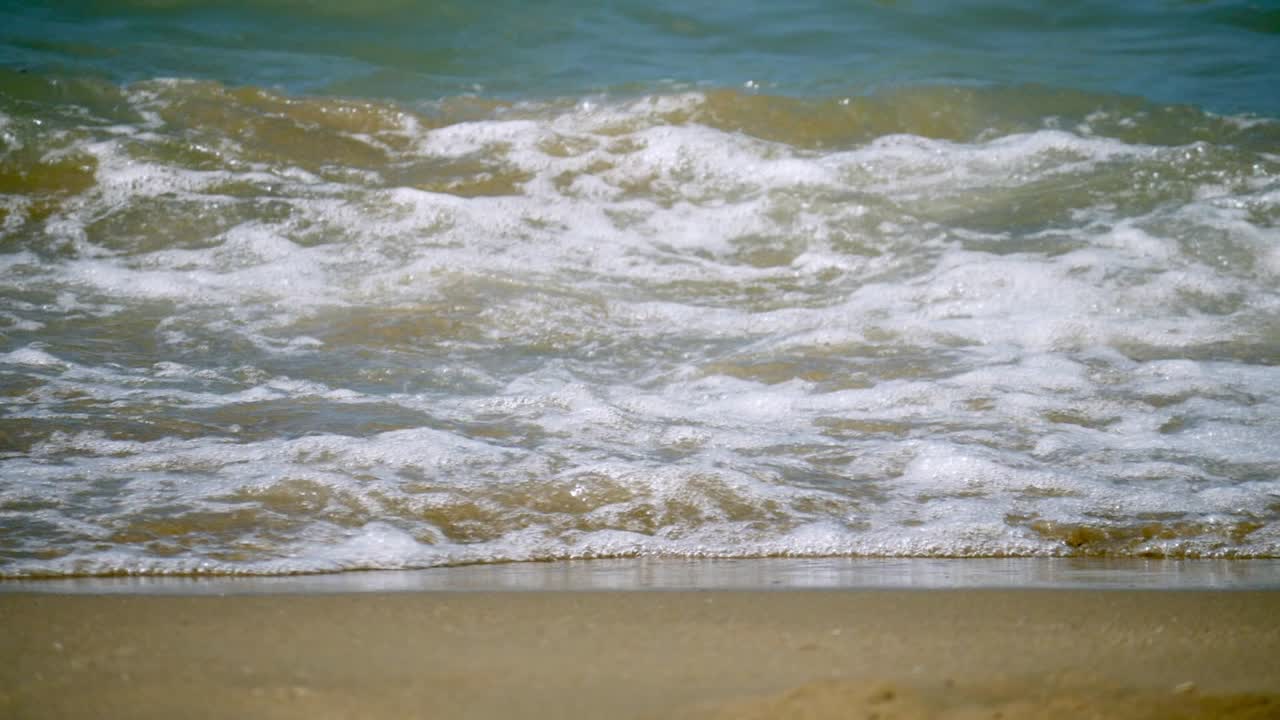 Waves surging and splashing at the beachfront of Pattaya Beach in Chonburi province, in Thailand