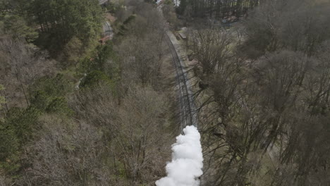 Disparo-Aéreo-En-Cámara-Lenta-Siguiendo-Un-Motor-De-Tren-De-Vapor-Que-Se-Mueve-Por-Las-Vías-En-Chattanooga,-Tn