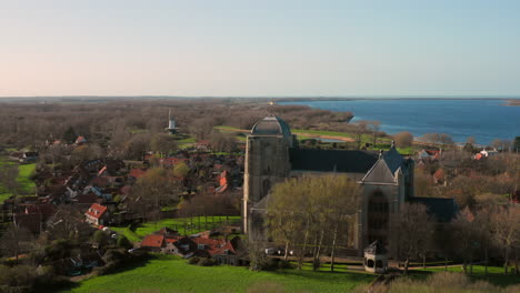 aerial: the historical town of veere with an old harbour and churches, on a spring day