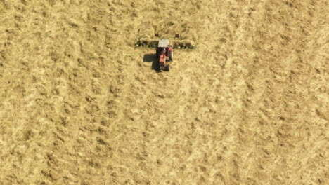 above view of a farm tractor with rotating hay rake