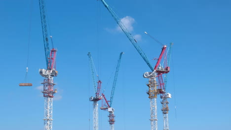 Aerial-view-of-a-large-construction-site-with-cranes-at-dusk