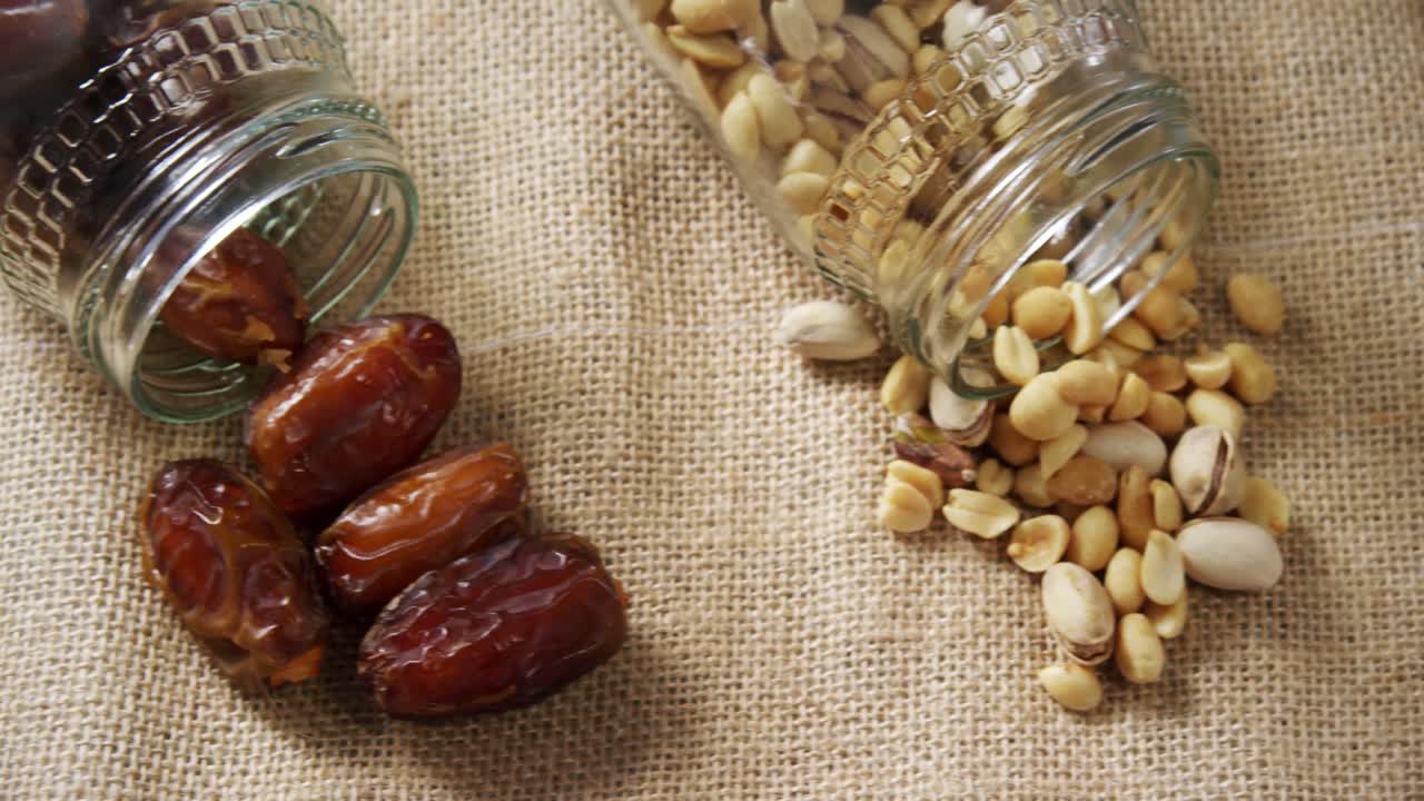 Various dried fruits on textile background 4k