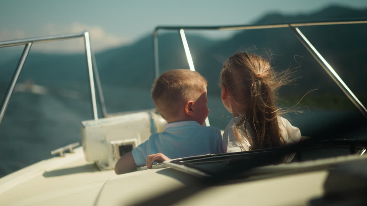 Little Children Look Out Of Motorboat Hatch Travelling Across Ocean On 