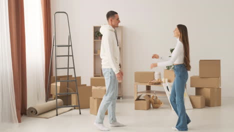 happy couple spinning around in new house