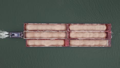 tow boat pushing hopper barge on ohio river, top down drone full shot