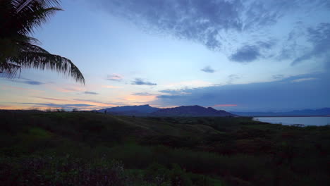 Stunning-orange-blue-sunset-cloudy-Malalo-island-Nadi-Suva-Tourism-Fiji-palm-coconut-trees-jungle-Funk-Fish-Beach-Resort-beautiful-peaceful-relaxing-mountain-hike-walk-nature-landscape-slow-pan-right