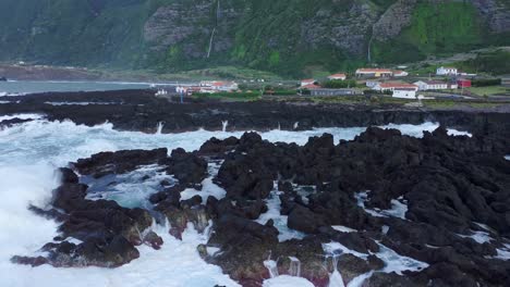 Rocky-coastline-at-Fajã-Grande-town-at-Flores-island---Drone-shot