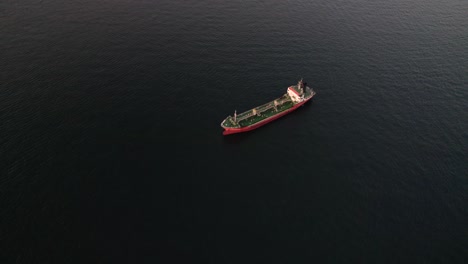 aerial view of a red tanker ship in the open ocean