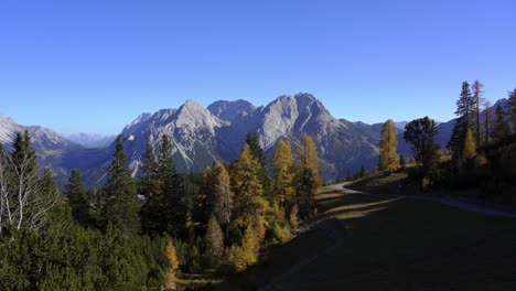 panning view showing a mountain hiking path in the alps in autumn