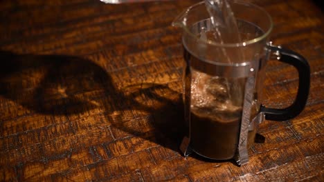 hot water being poured into a french press