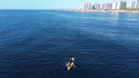 Aerial-view-of-kayak-fishing-at-seascape,-trolling-fishing-drone-view