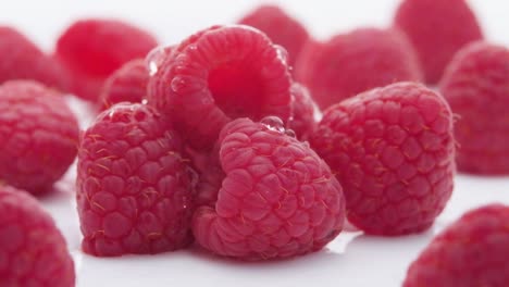 Healthy-food-organic-nutrition,-water-falling-down-Fresh-raspberry-fruits,-Close-up