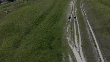 couple hiking on a hilltop trail