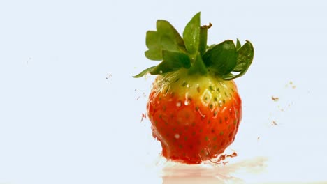 Strawberry-falling-on-water-against-white-background-4k