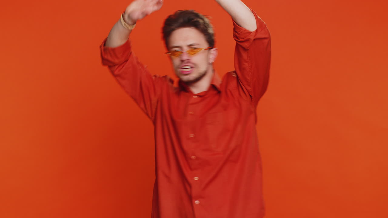 Stylish man listening music dancing disco fooling around having fun celebrating success victory