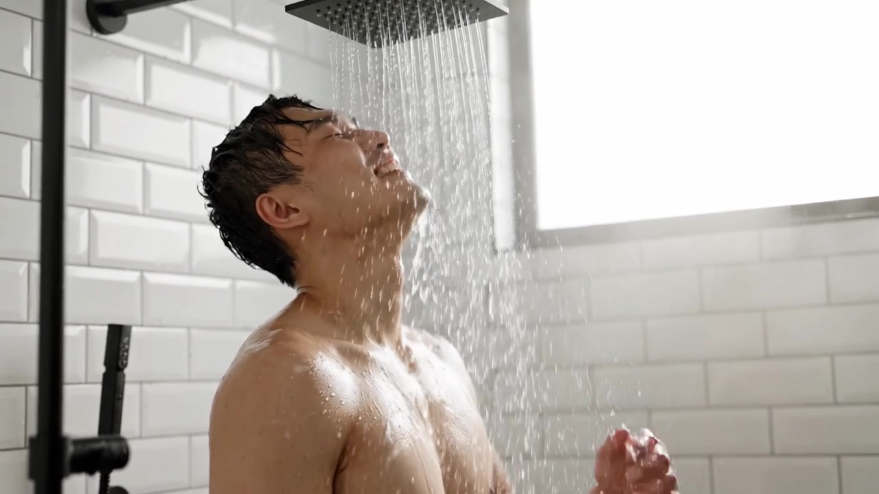 A Serene Shower Experience: Capturing Moments of Relaxation and Reflection Under a Flowing Waterfall in a Modern Bathroom Setting