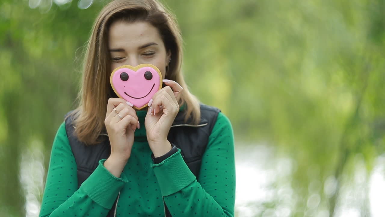 Young Girl With Cookies. Young smiling woman with cookies in hands