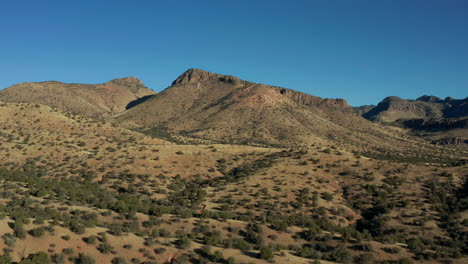 aerial view of desert landscape saddle with arid mountains behind, 4k