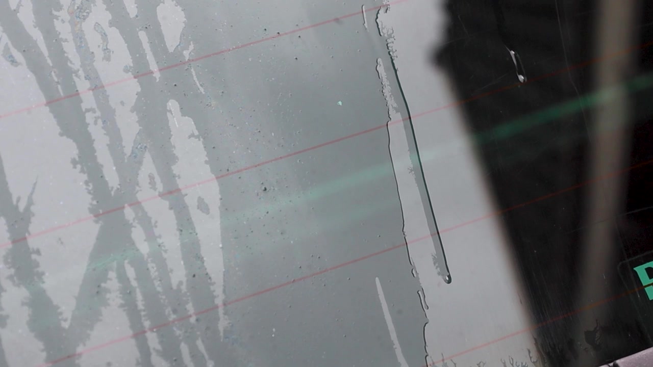 Video of water running down car window while cleaning.