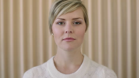 close up portrait of elegant young blonde woman looking confident serious at camera beautiful perfect skin