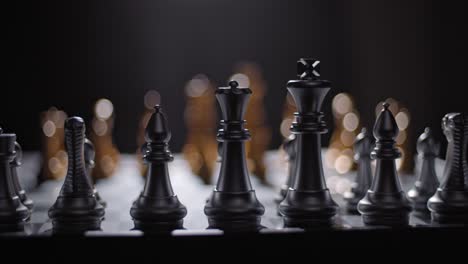 silver chess pieces lined up and ready for battle - shallow focus trucking shot