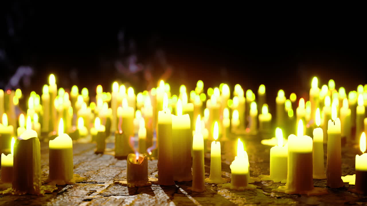 Many candles glowing softly in a dark space create a serene atmosphere
