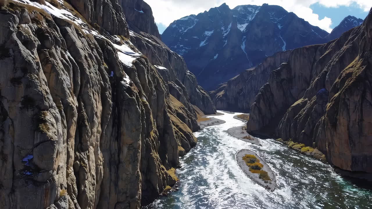 Majestic River Flowing Through a Deep Canyon with Snowy Peaks