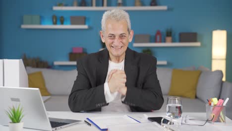 home office worker man looking at camera clapping and getting excited.