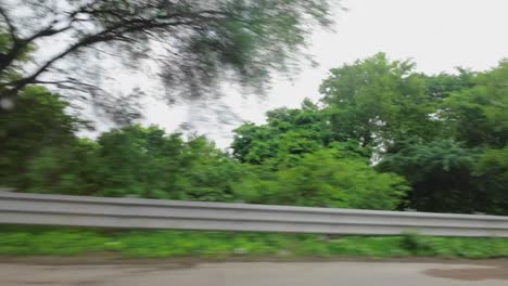 car traveling love side window trees moving in rainy day india