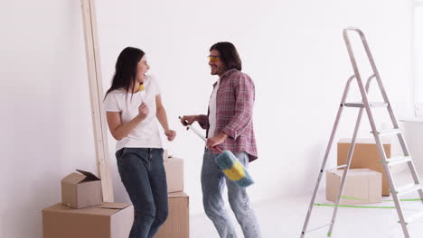 happy couple dancing during a home renovation