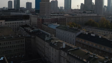 Fly-above-town-development.-Tilt-up-reveal-of-downtown-high-rise-office-buildings-against-bright-sky.-Warsaw,-Poland