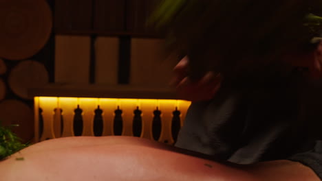 herbal back massage in a sauna
