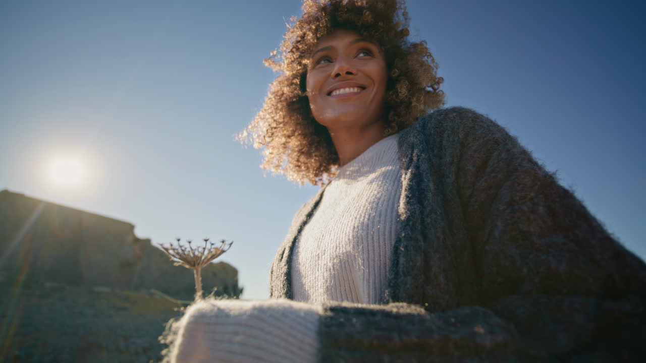 Walking girl looking distance at blue sky background closeup. Happy woman posing