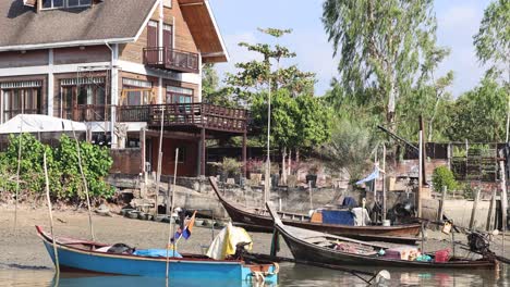 boat navigates past riverside houses and docks